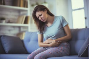 woman with pain due to irritable bowel syndrome IBS
